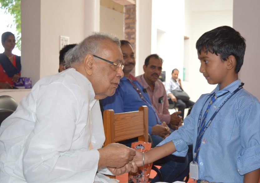 A trustee's visit — greeting the school's youngest students