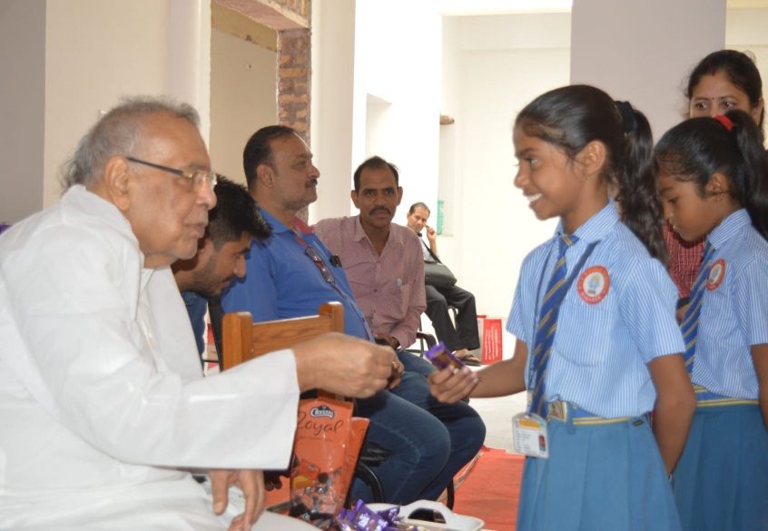 A trustee's visit — greeting the school's youngest students